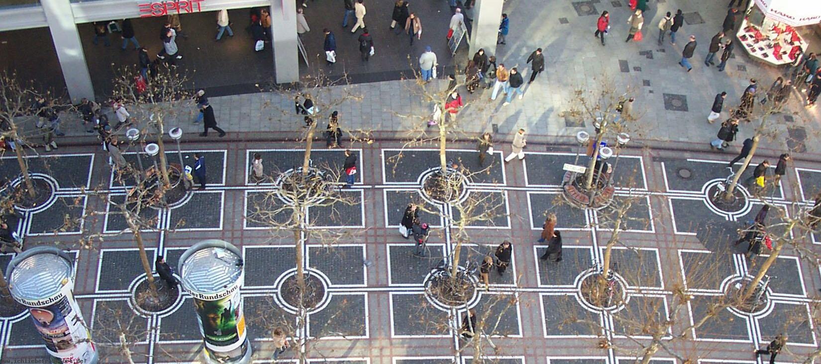 DURCHEINANDER wirkt die Zeil durch die Teerflecken im Pflaster, die berbaute Fugngerzone und die dunklen Granit-Platten darunter. < >Warum ist das Haus (an so brisanter Stelle) in die Zeil hineingebaut worden? Schon bei der Baugenehmigung standen Lden- und Broflchen auf der Zeil leer!! Unbegreiflich die Kurzsichtigkeit unserer Legobaustein-Architekten. (Zugegeben, Legofarben benutzen sie nicht; glauben sie doch, Grau und Schwarz macht ihre Glas- Plattenbauten zu Kunstwerken.) < >